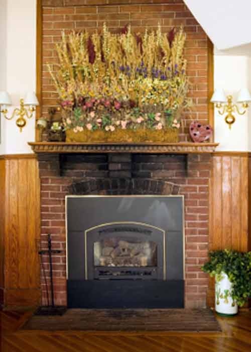 Brick Fireplace Pictures; Creative Artistic Mantel Flower Decoration on Brick Fireplace